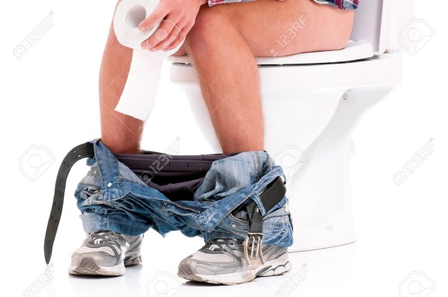 19738027-Man-is-sitting-on-the-toilet-bowl-holding-paper-in-hands-on-white-background-Stock-Photo